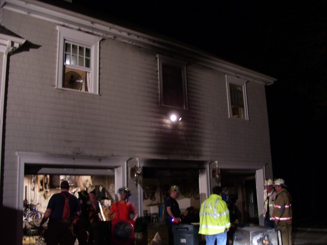 Members after knocking down a garage fire.